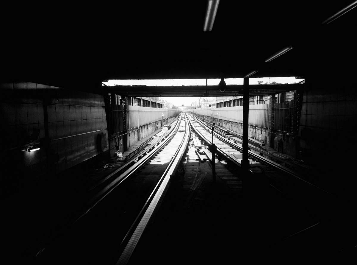 train track grayscale photography of subway track railway